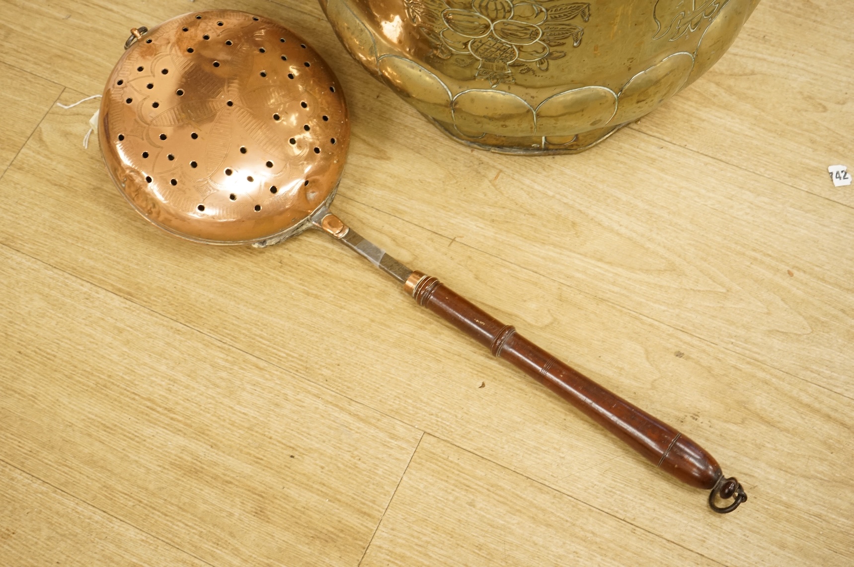 A 19th century Dutch brass coal bin, a pair of wall sconces, a copper bed warmer and three book slides